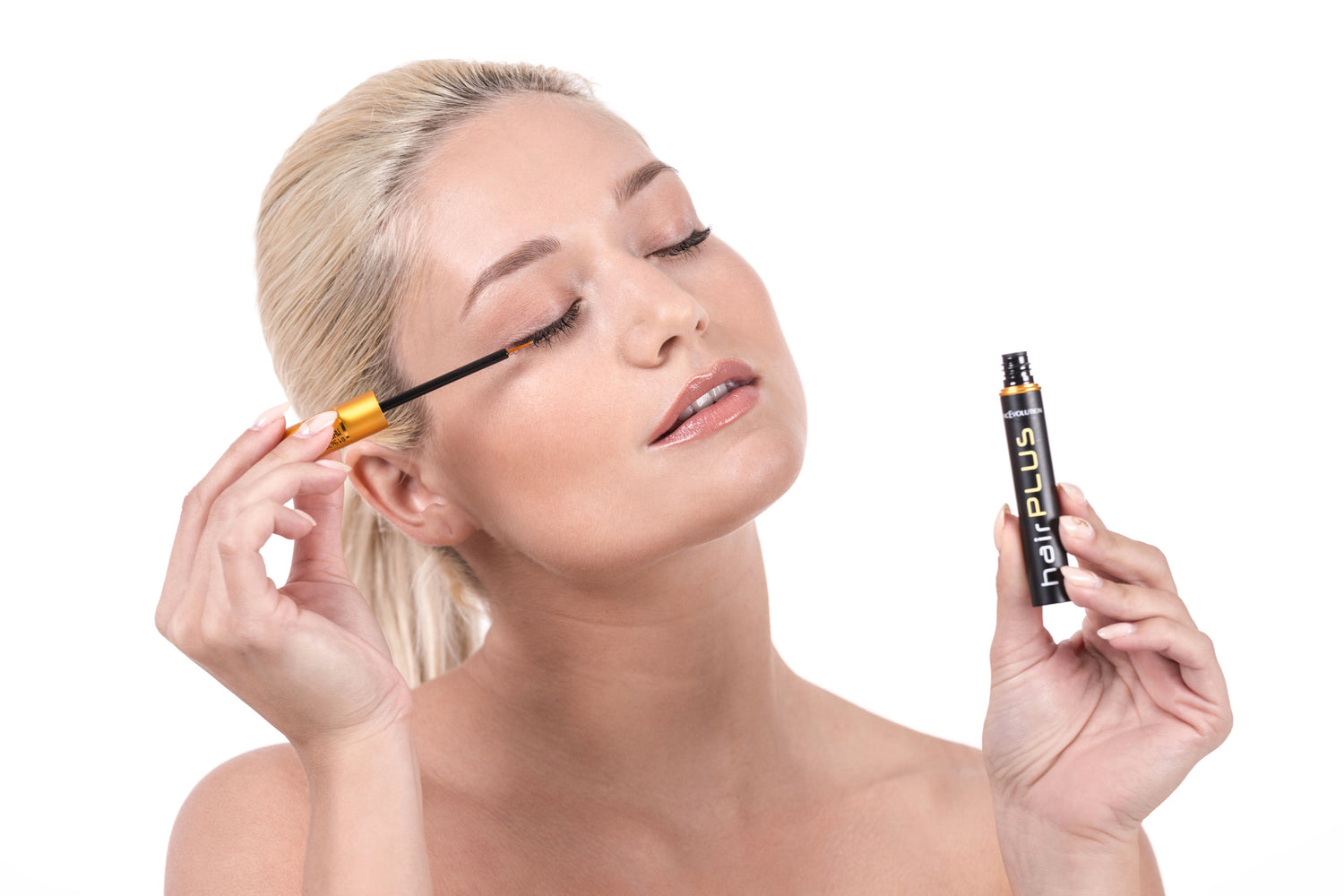 Woman applying eyelash serum for longer and fuller eyelashes.